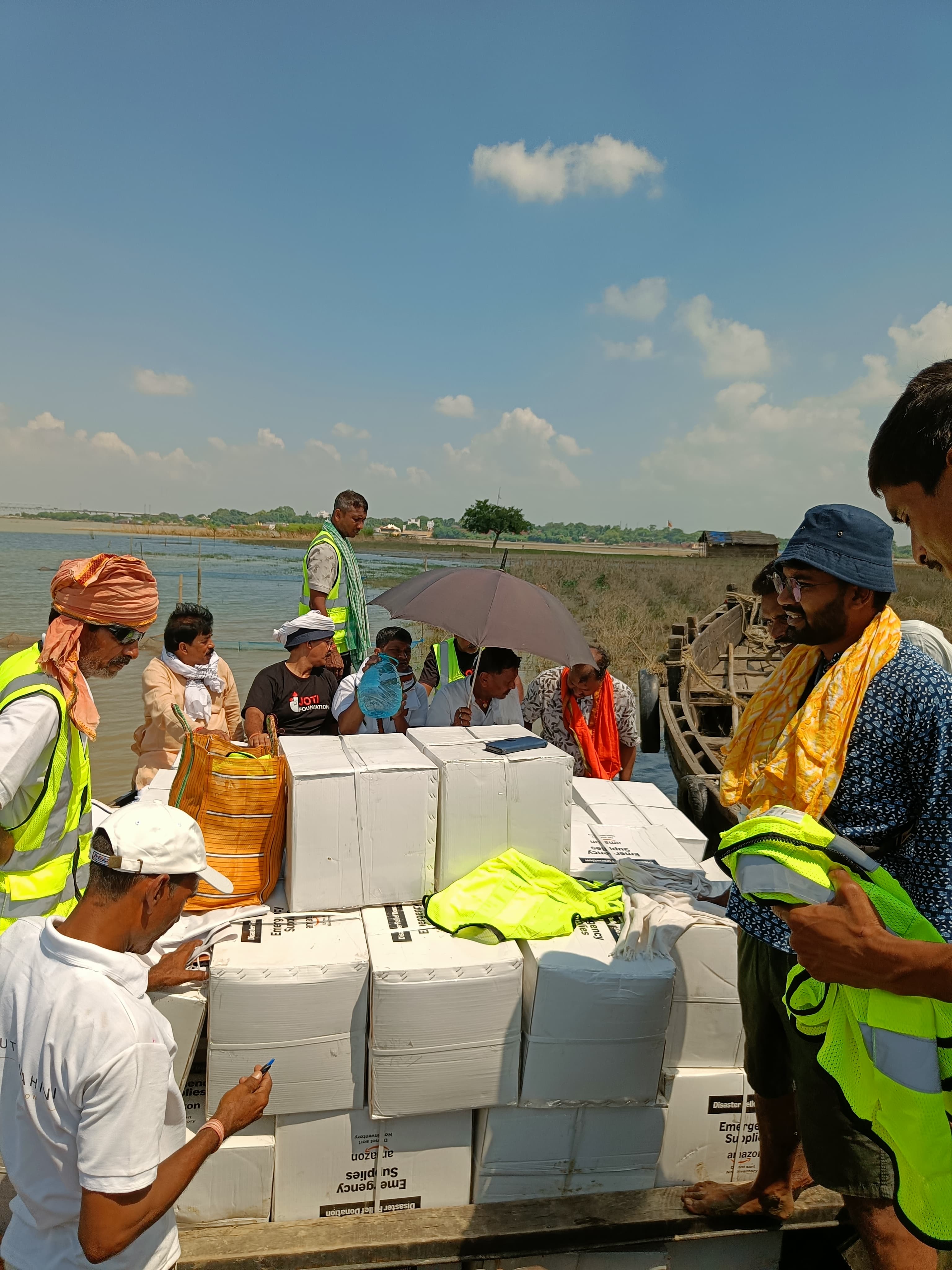 Relief team navigating floodwaters by boat to deliver emergency supplies in Bihar