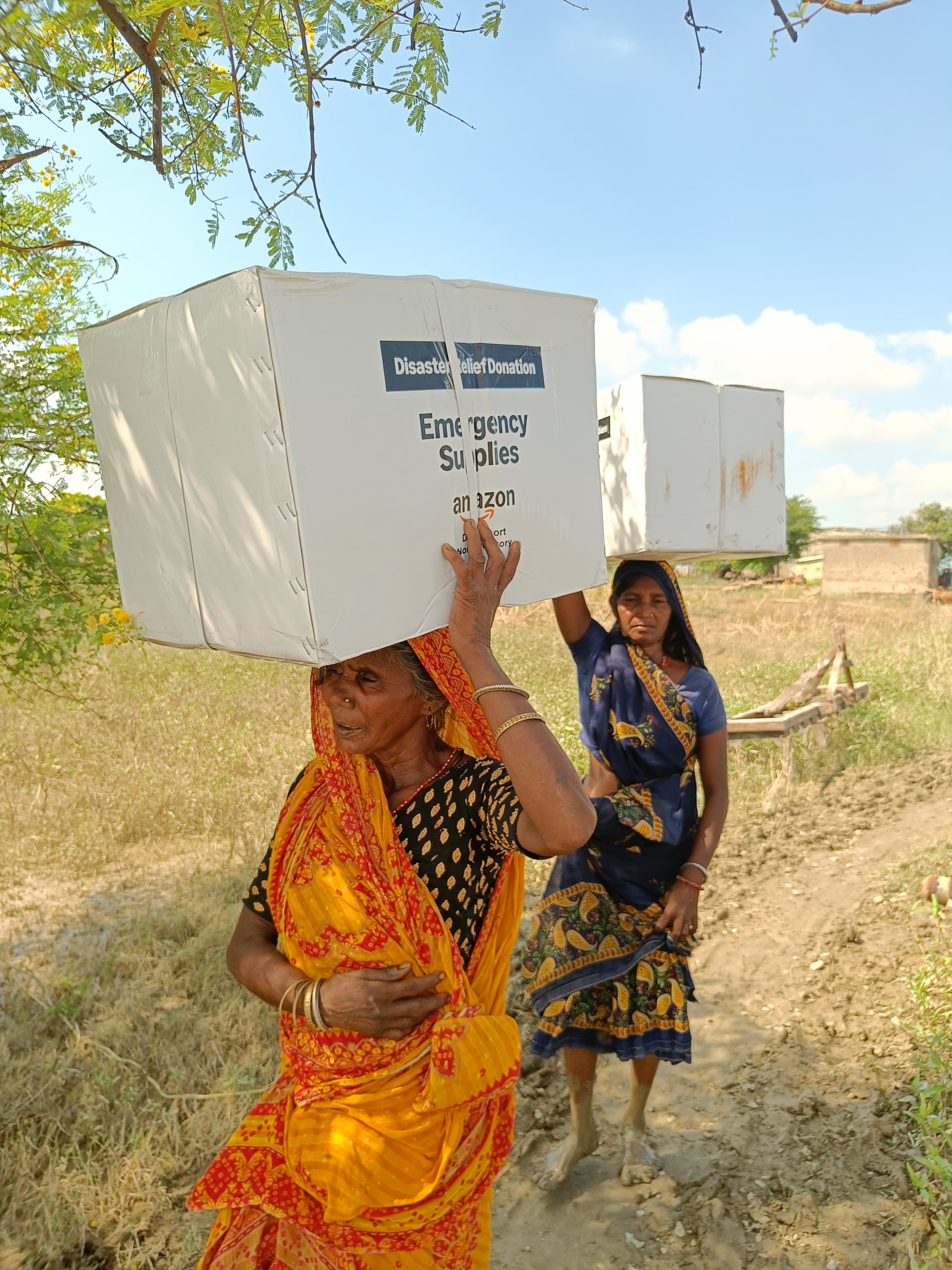 Families carrying emergency relief rations to safety in Bihar